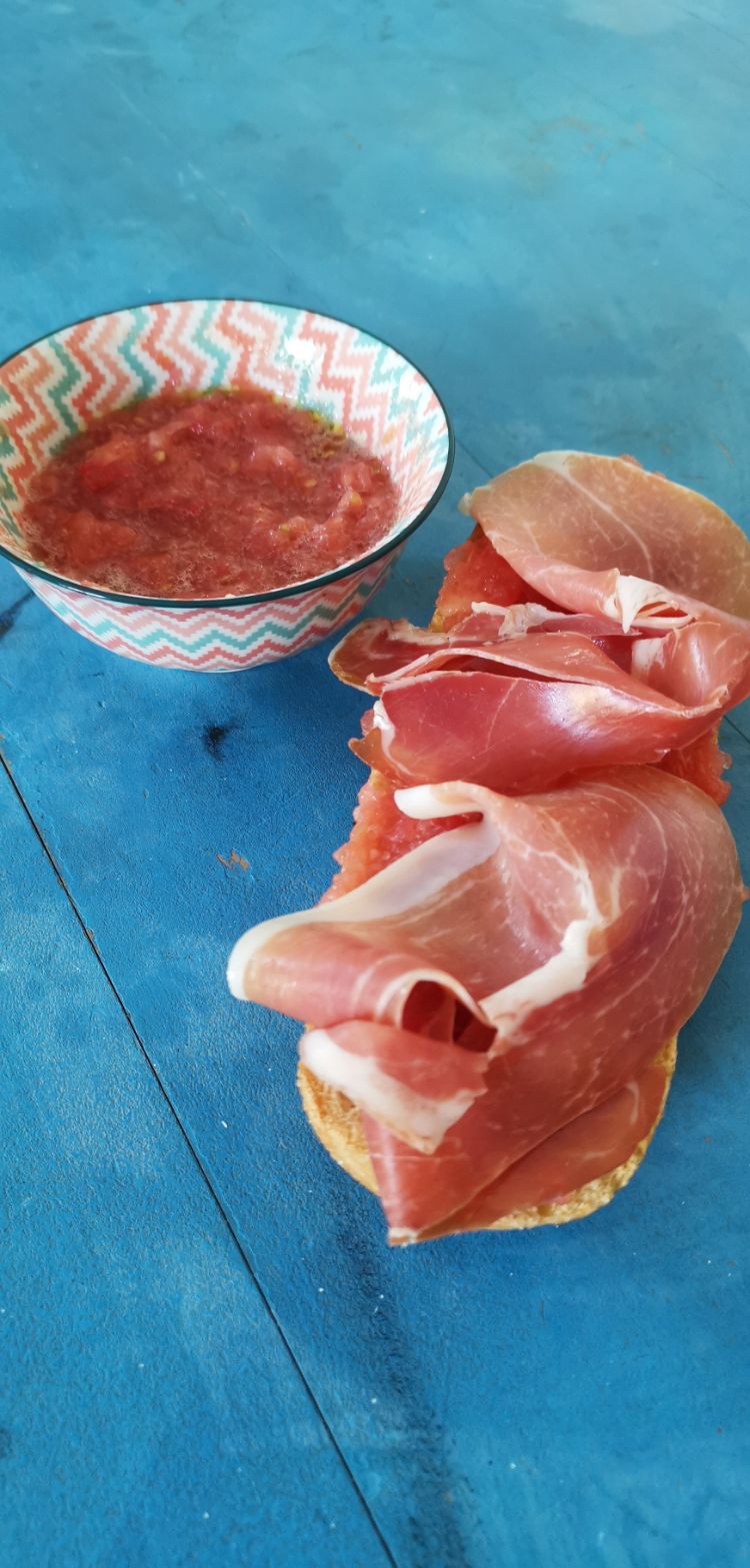 Spanish breakfast with toasted bread, ham and olive oil.