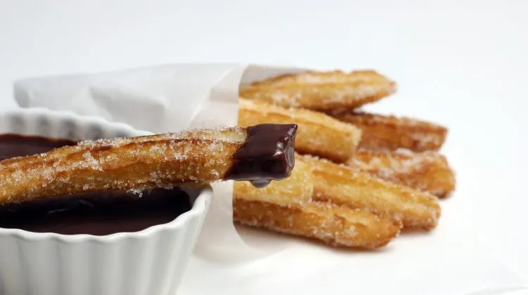 20 Traditional Spanish Desserts + Spanish Dessert Recipes 4 spanish churros with a chocolate dip