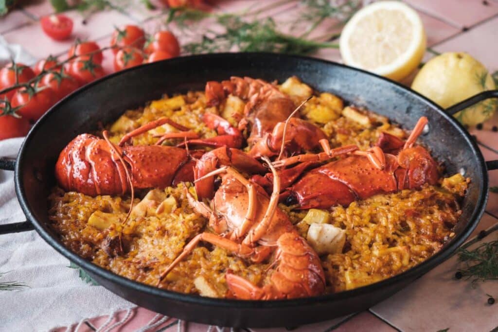 Paella de marisco with lobster, shrimp, and mussels in a paella pan